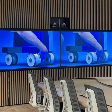 Boardroom with twin large-format displays and a central conferencing camera