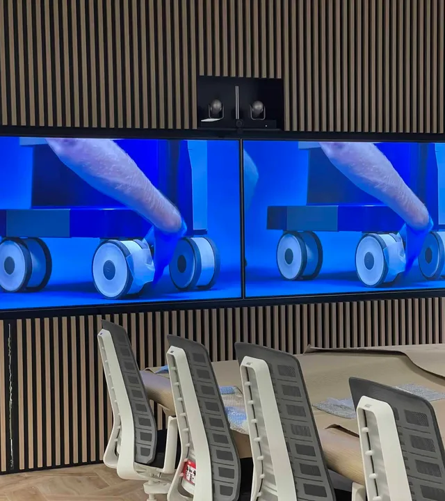 Boardroom with twin displays and a video conferencing camera above them