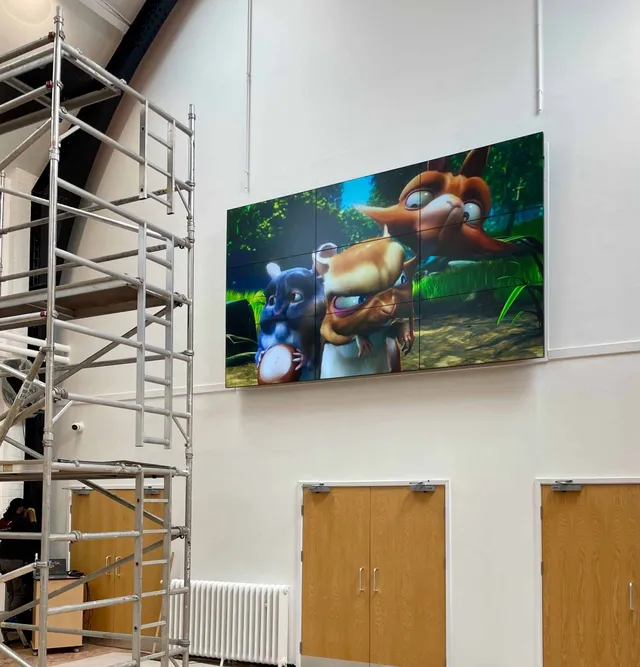 Large display showing a video game character installed high on an entertainment venue wall