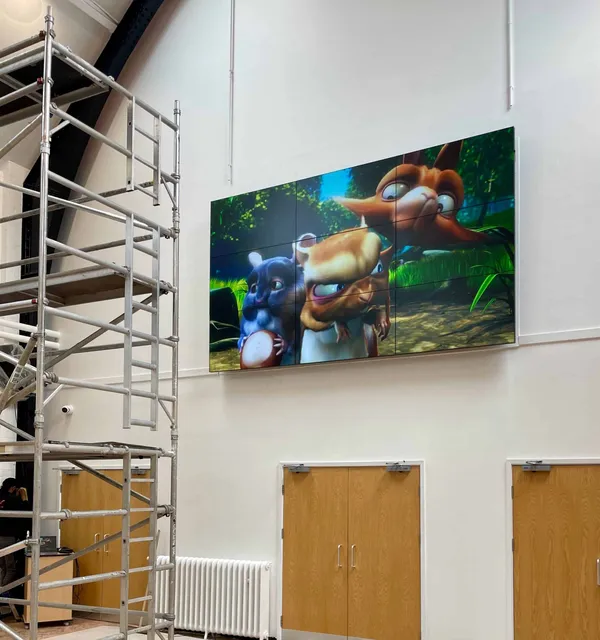 Large display showing a video game character installed high on an entertainment venue wall