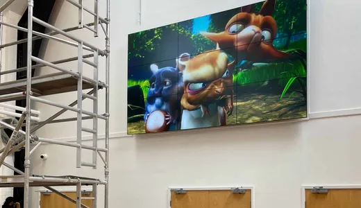 Large display showing a video game character installed in an entertainment venue