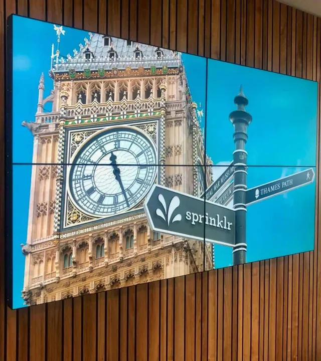Four-screen videowall showing Big Ben installed on a timber-clad wall