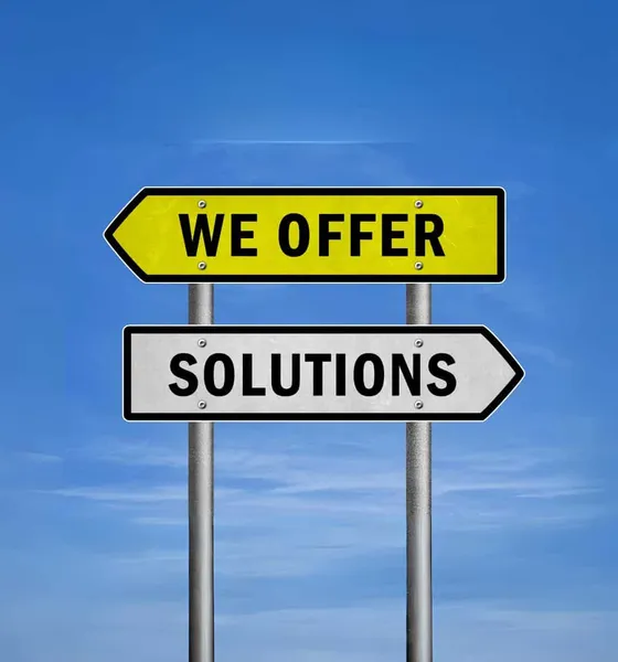 Road signs reading We offer solutions against a blue sky